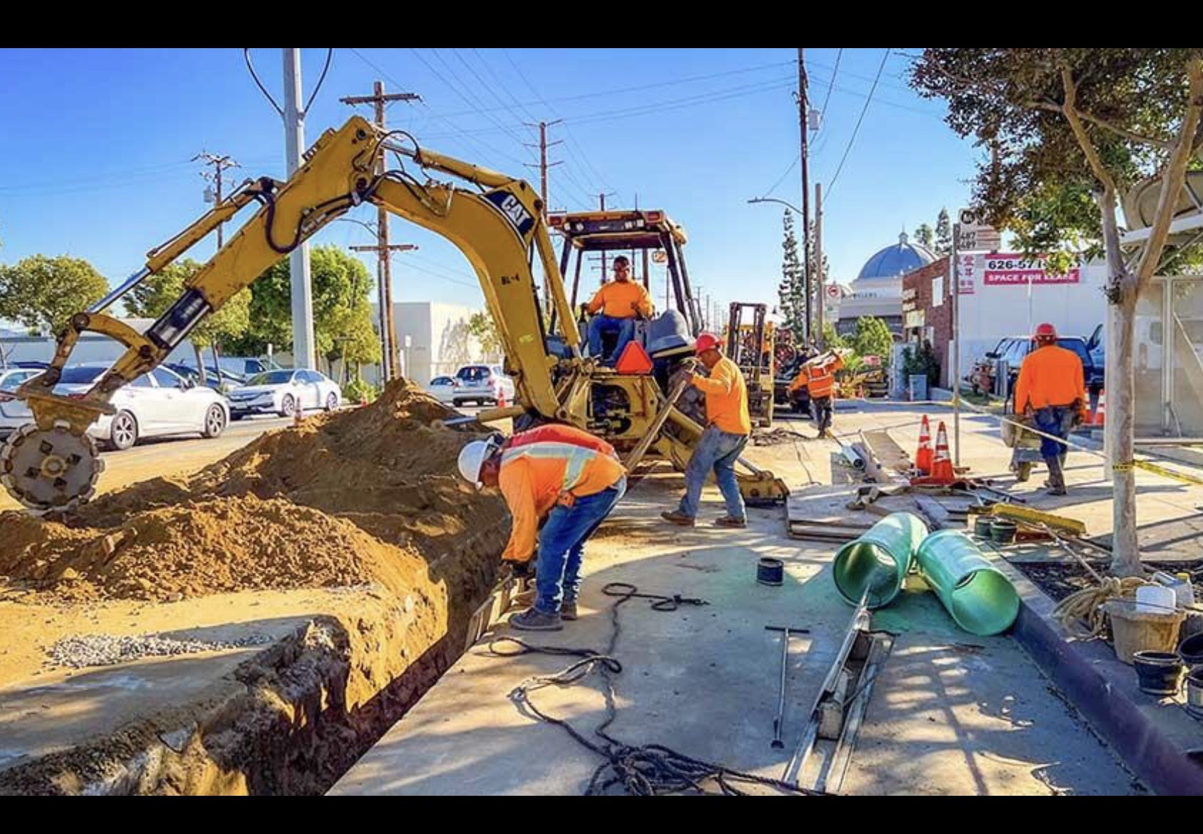 Utility crew excavating a street to replace buried pipeline